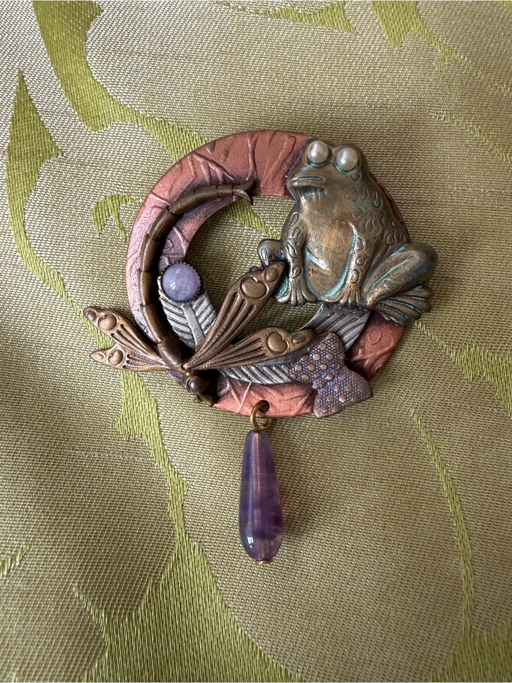 Brooch with whimsical frog and dragonfly on wreath in mixed metals. See photos